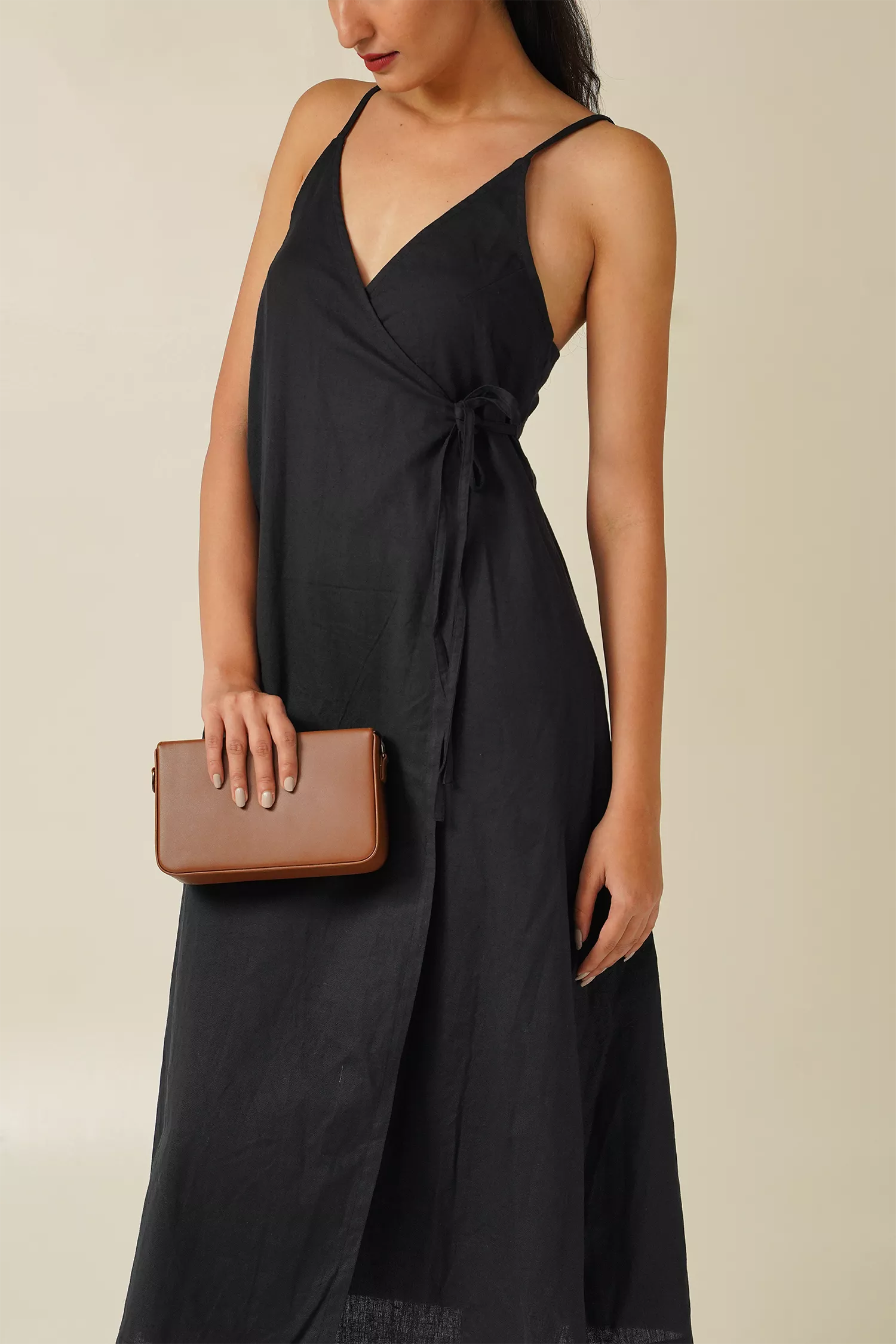 close-up view woman wearing Odd Lama black cotton wrap, sleeveless A-line dress