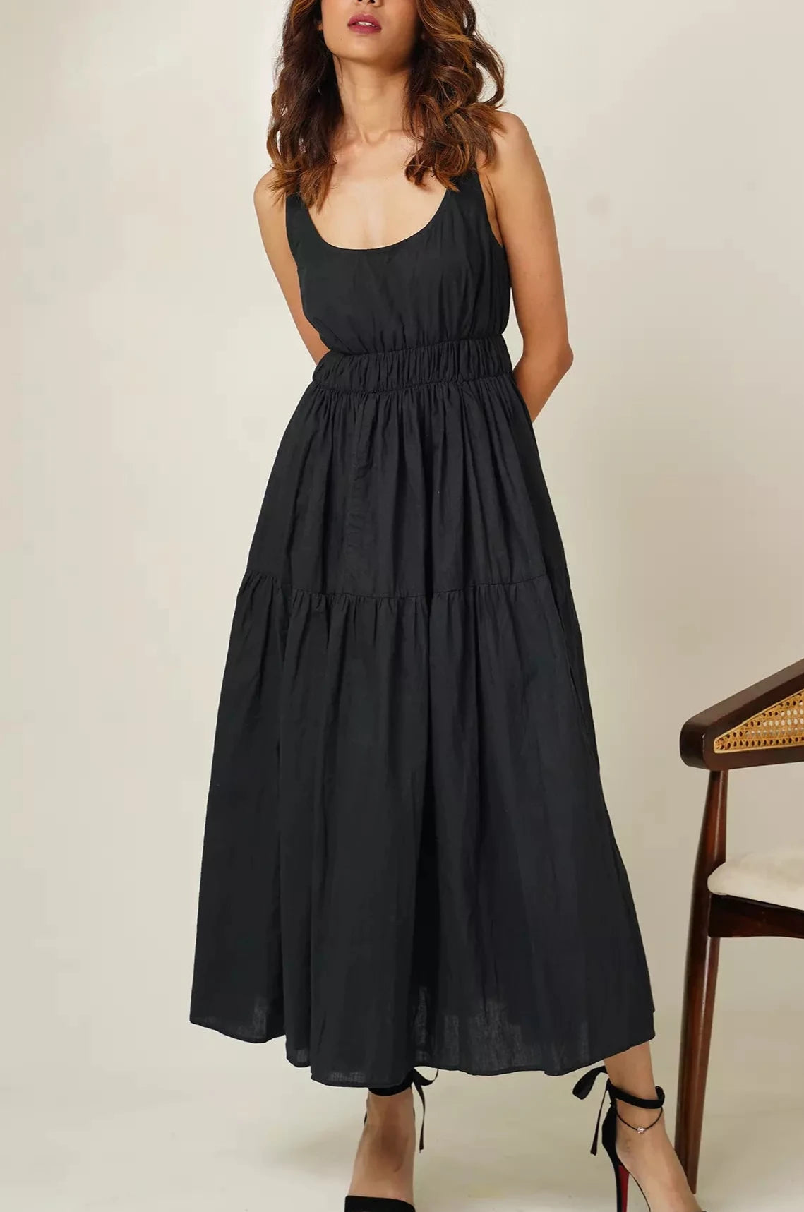 Front close up view of woman wearing the odd lama ankle length black tiered dress in pure cotton