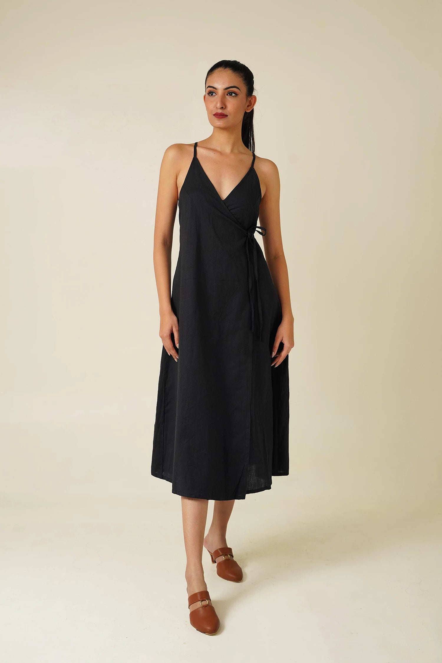 Front-view-woman wearing Odd Lama black cotton wrap, sleeveless A-line dress 